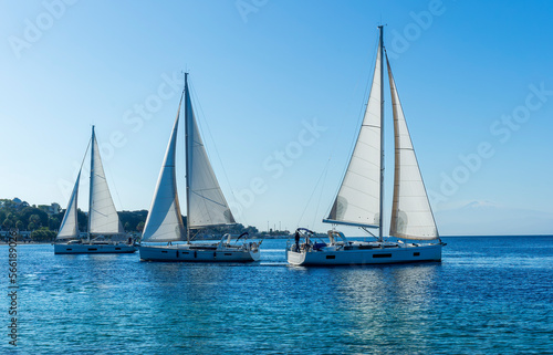 boats and yachts at the sailing regatta on open water. Sailing on the wind waves in the sea. © Yaroslav