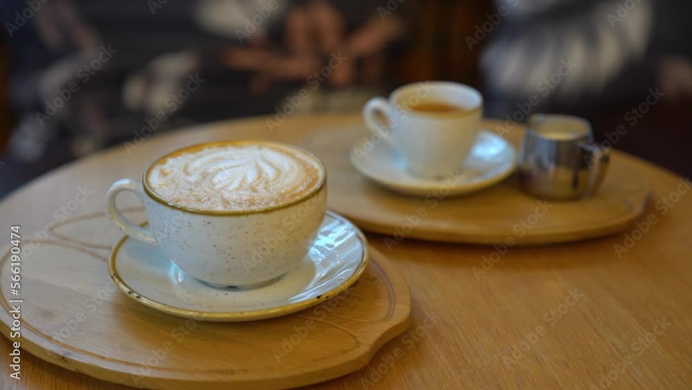 latte art coffee in a white cup on wooden table. espresso. interior detail. latte art coffee in a white cup on wooden table. espresso. interior detail.