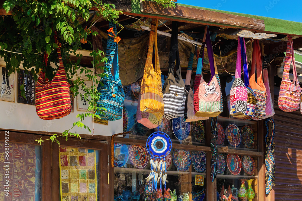 Fototapeta premium Traditional Turkish colorful handbags on store in bazaar market. Travel souvenirs and gift concept Side city, Antalya region, Turkey (Turkiye). Aug 11, 2022