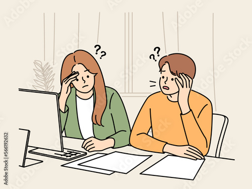 Unhappy couple confused with paper bills 
