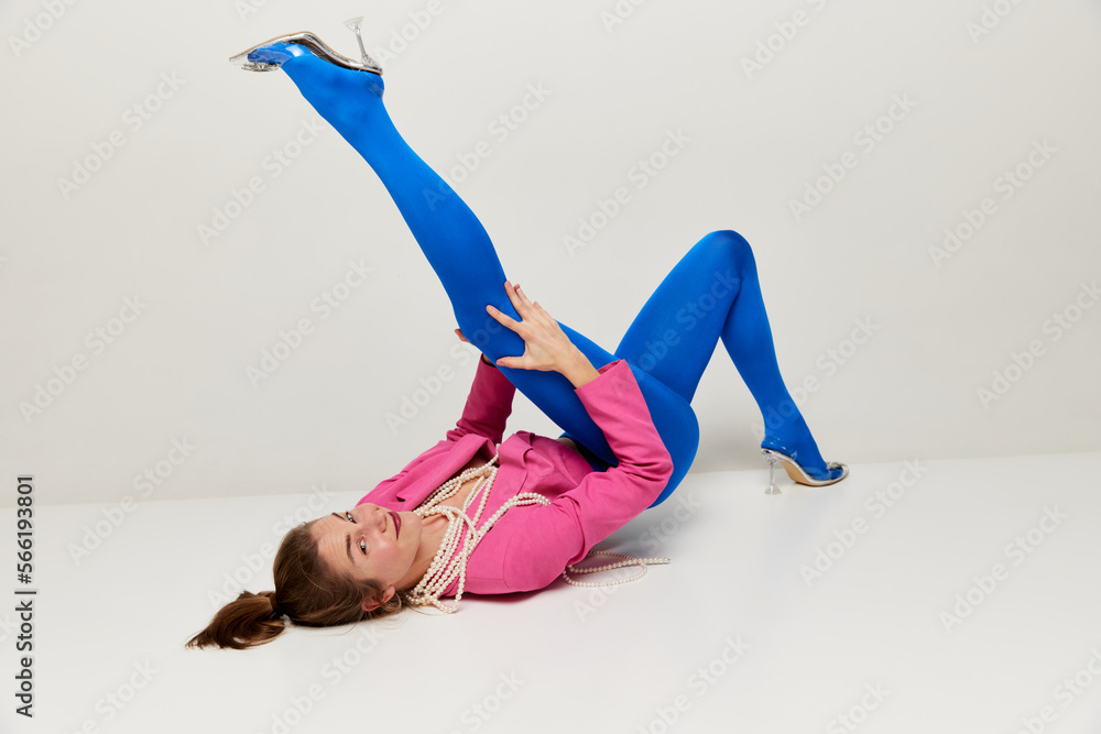 Emotional young stylish girl in blue tights and pink croptop