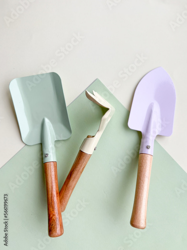 Flat lay composition with gardening tools on light green background