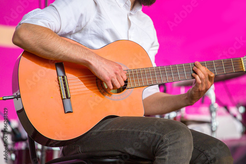 a musician plays an electric guitar on a city street.