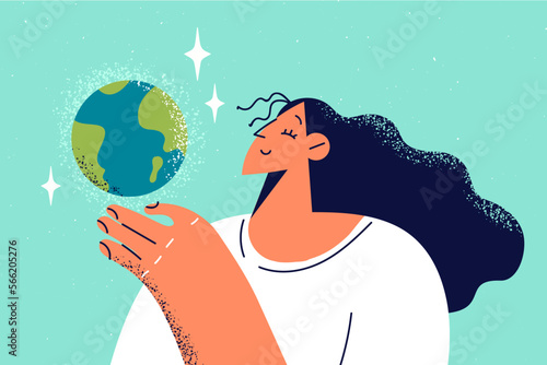 Smiling woman holding planet earth in hands 
