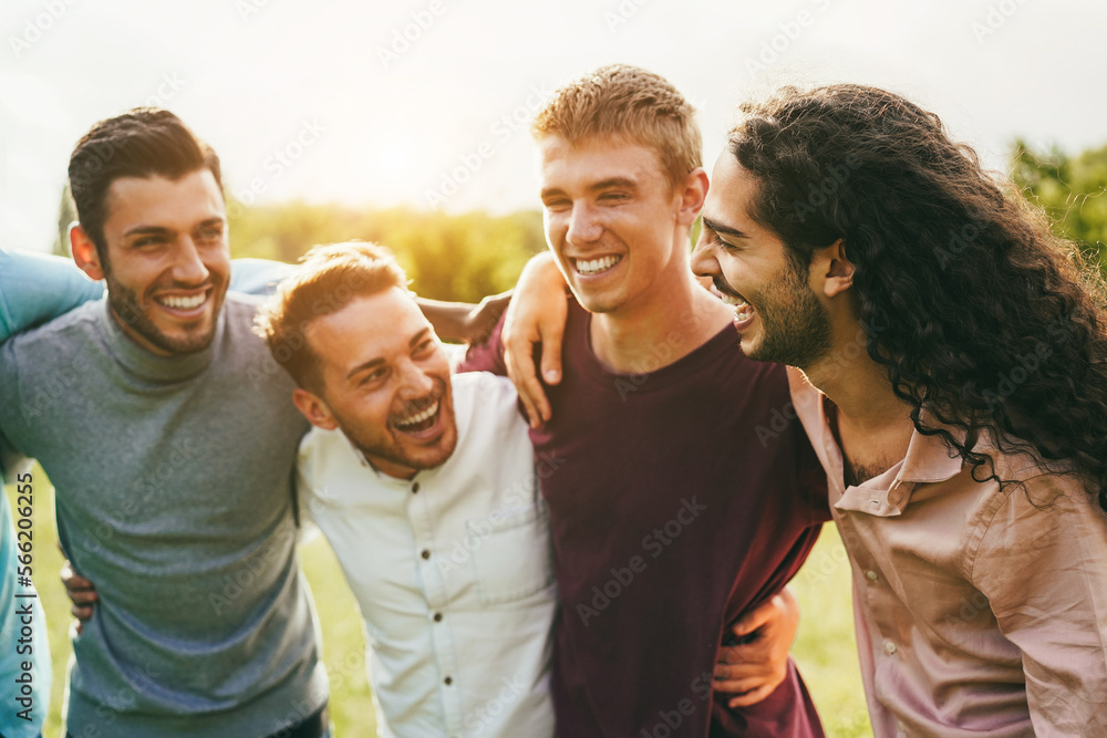 Happy male friends having fun together outdoor - Focus on right guy face