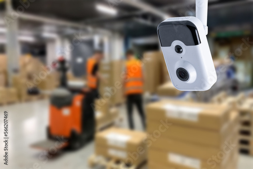 CCTV Camera Operating inside warehouse or factory. Copy space.