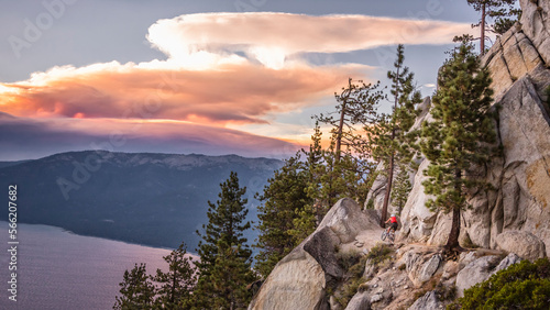 A woman is mountain biking on the Flume Trail.