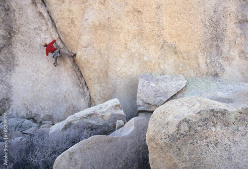 Man rock climbing in Joshua Tree National Park, California, USA