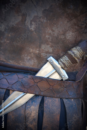 Close up of medieval dagger in leather belt.