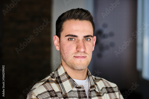 Portrait if a young man at home looking at camera. photo