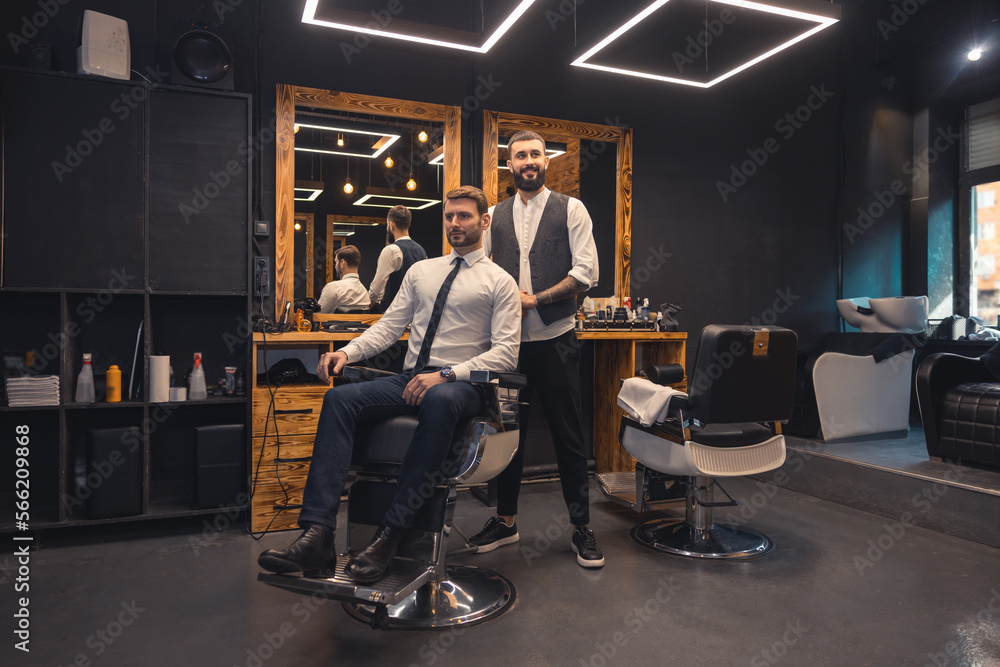 Elegant client sitting in a chiar in the barbershop