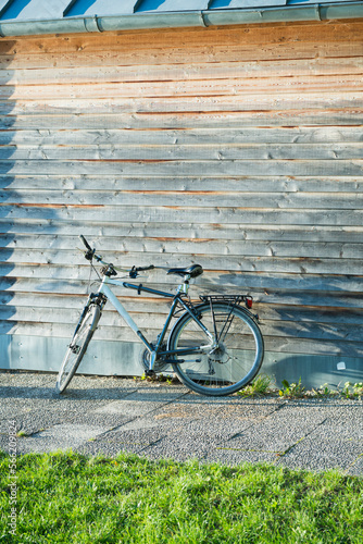 Mountainbike bicycle leaning on wooden shed photo