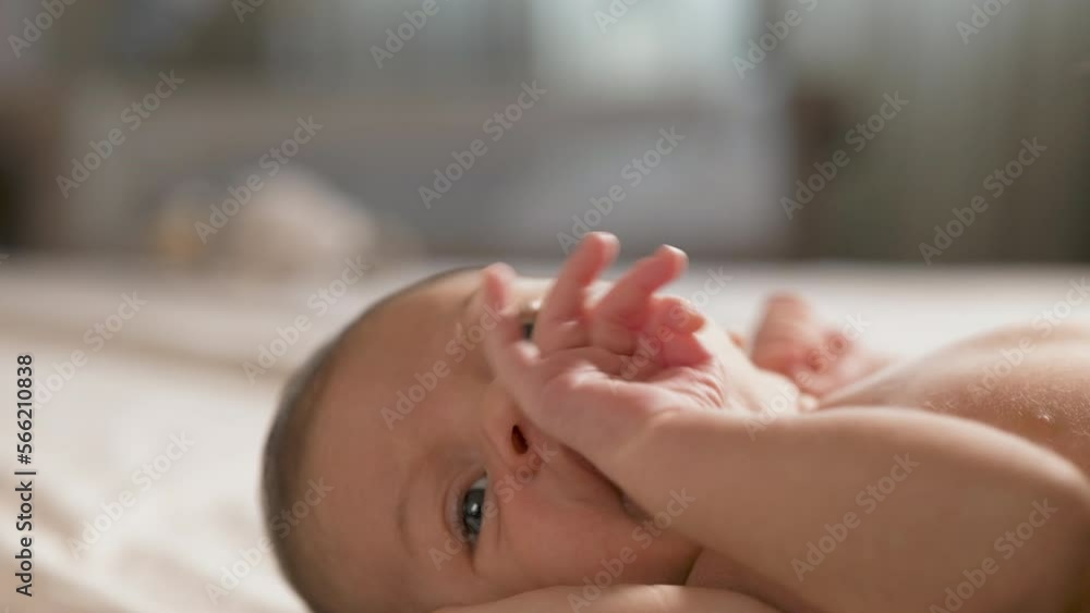 Slow Motion Portrait of New Born Baby Resting Peacefully in the Arms of his Mother as She Leens to Kiss him. Woman New to Motherhood Expressing her Unconditional Love to her Child and Bonding with Him Slow Motion Portrait of New Born Baby Resting Peacefully in the Arms of his Mother as She Leens to Kiss him. Woman New to Motherhood Expressing her Unconditional Love to her Child and Bonding with Him