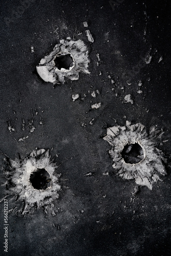 Foto Bullet hole in composite body armour.