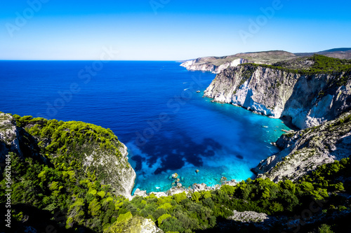 Beautiful crystal clear blue and turquoise waters next to a rugged, overgrown coastline that makes a wonderful play of colors, Keri, Zakynthos, Greece
