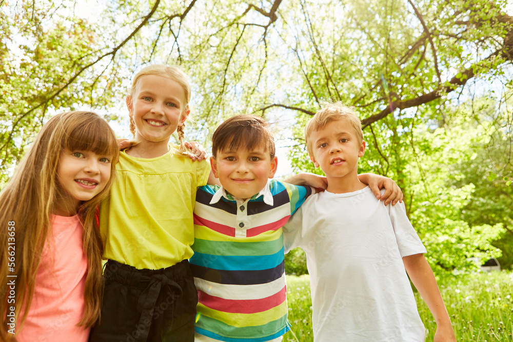 Fototapeta premium Happy group of children together in green garden in summer
