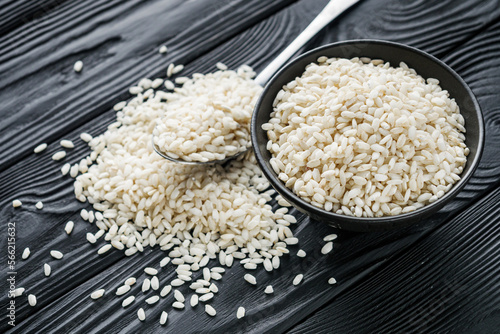 arborio rice for risotto on a black wooden background photo