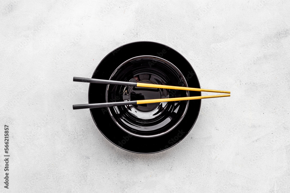 Black bowl with golden chopsticks for Asian tabble place setting Black bowl with golden chopsticks for Asian tabble place setting