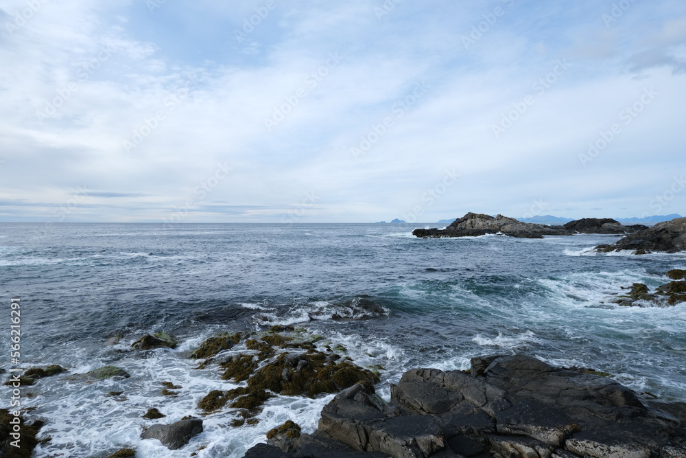 Rocky coastline of the ocean bay, cloudy sky Rocky coastline of the ocean bay, cloudy sky