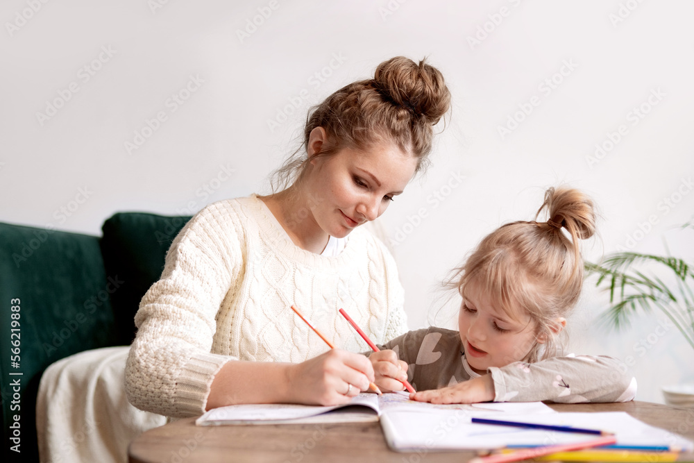 Happy mom engaged in her child's development, homeschooling in a friendly environment Happy mom engaged in her child's development, homeschooling in a friendly environment