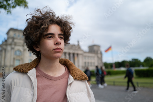 Photography Portrait of a white teenager in front of the German parliament in Berlin on a cl