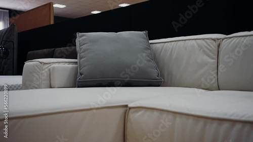 The filmed frame approaches a gray pillow, on a comfortable white sofa. 4k video.