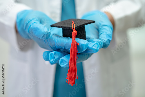 Asian doctor study learn with graduation gap hat in hospital ward, clever bright genius education medicine concept.