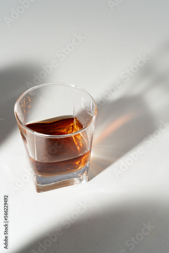 Close up of single glass whiskey with creative lights background