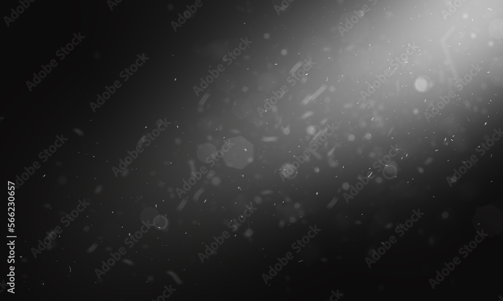 Fototapeta premium A beam of white light with flying dust on a black background. Winter background with flying snow. Snowstorm, blizzard, dust. High quality photo