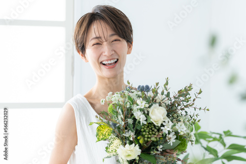 花束を持った笑顔のミドル女性
