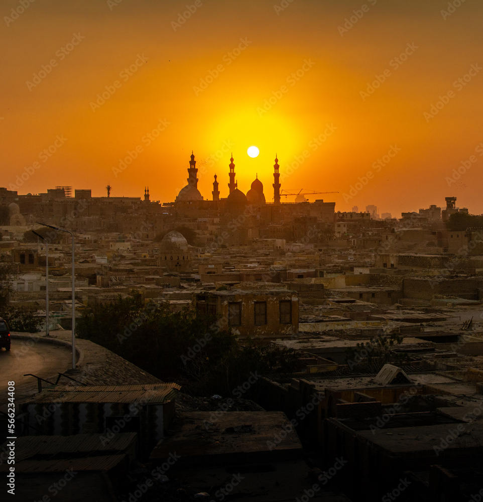 Orange sunset in square format of the city of the dead in Cairo, Egypt