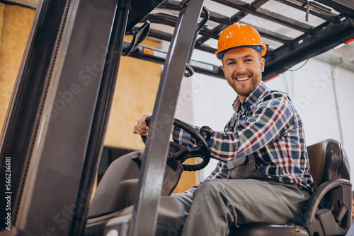 Man working at warehouse and driving forklift