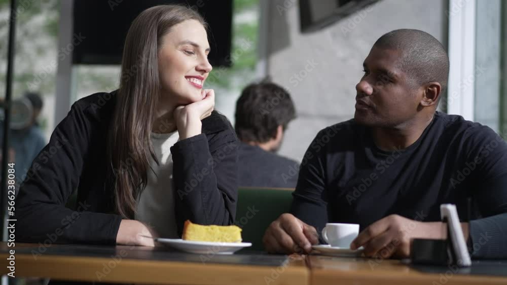 Two people seated at coffee shop. Diverse man and woman at cafe place daydreaming Two people seated at coffee shop. Diverse man and woman at cafe place daydreaming