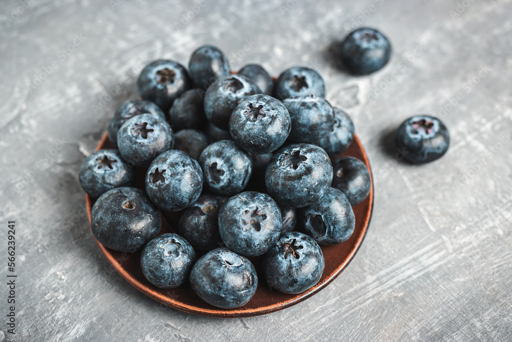 Fresh blueberries in a plate on a table, close up view Fresh blueberries in a plate on a table, close up view