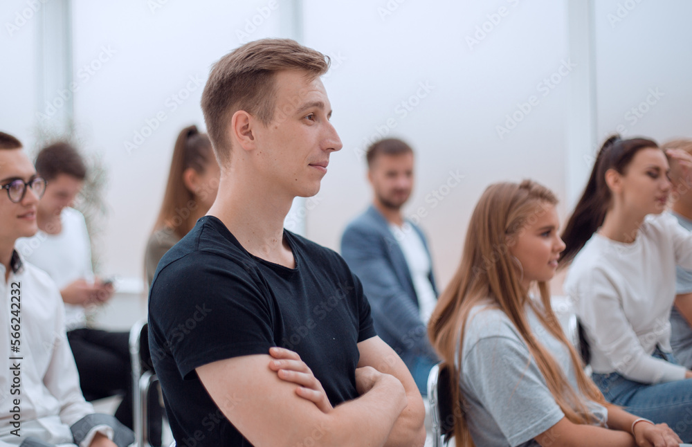 side view. casual group of young people sitting in conference room