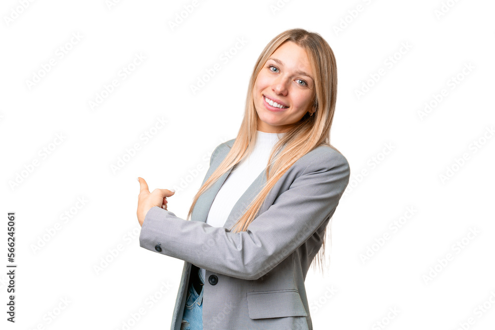 Young pretty blonde woman over isolated chroma key background pointing back Young pretty blonde woman over isolated chroma key background pointing back
