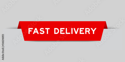 Red color inserted label with word fast delivery on gray background