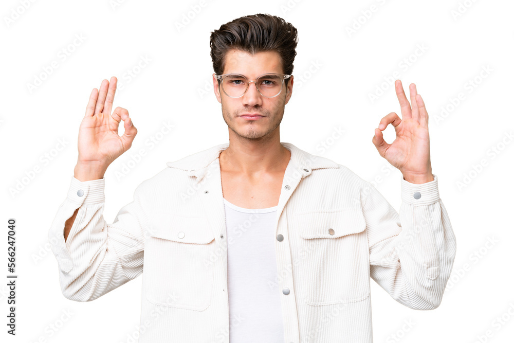 Young handsome caucasian man over isolated background in zen pose Young handsome caucasian man over isolated background in zen pose