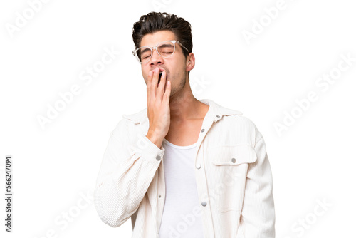 Young handsome caucasian man over isolated background yawning and covering wide open mouth with hand © luismolinero