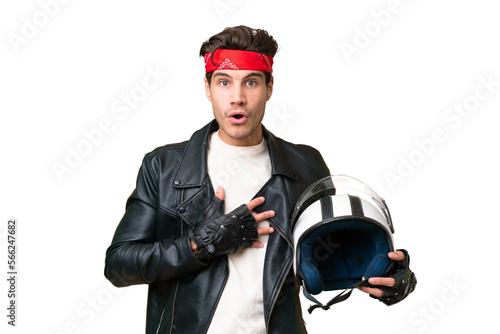 Young caucasian man with a motorcycle helmet over isolated background surprised and shocked while looking right