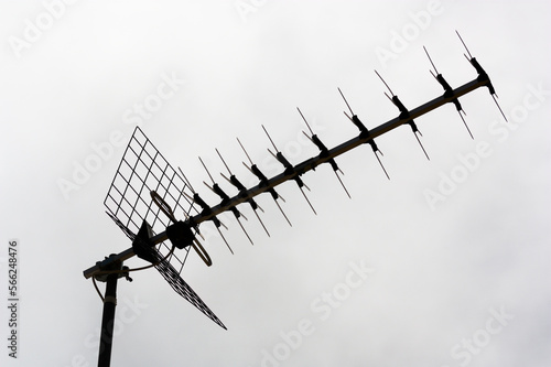 Close-up of a terrestrial digital tv antenna against the backlight of the cloudy sky