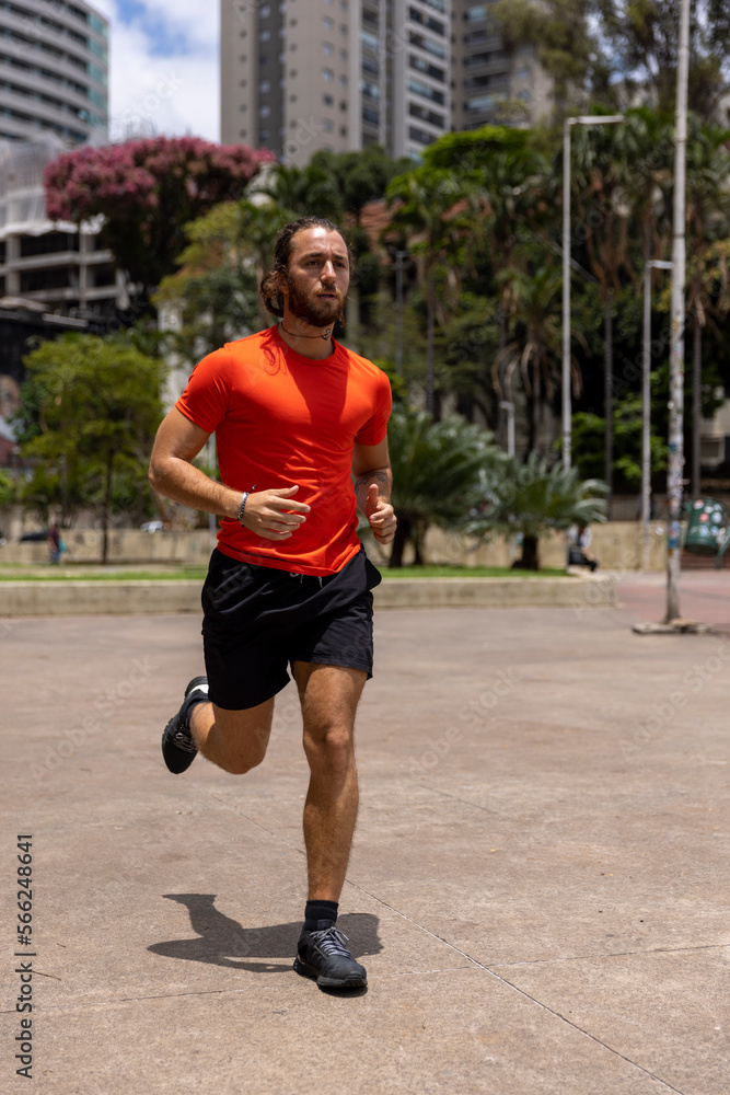 Brazil, Sao Paulo, Man in sports clothing jogging in park
