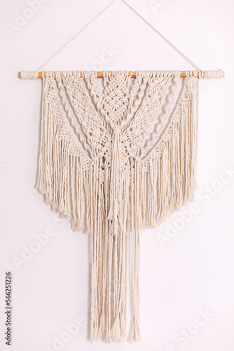 Wall panel in style of Boho made of cotton threads using the macrame technique for home decor and wedding decoration. Cozy Home decor concept. White Macrame in living room with boho interior design