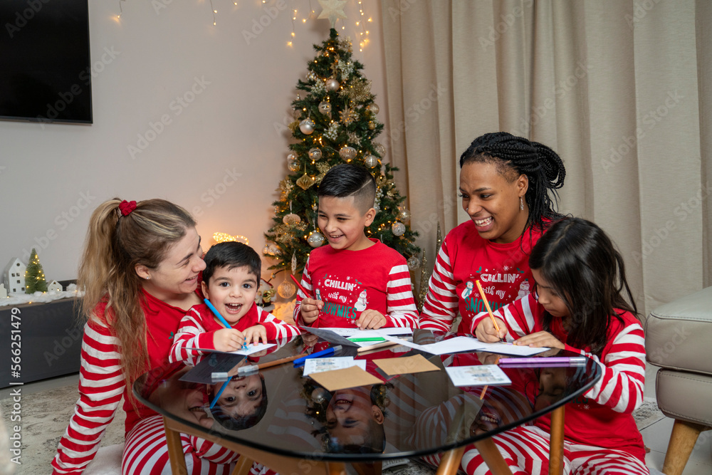 Moms with kids preparing Christmas cards at home Moms with kids preparing Christmas cards at home
