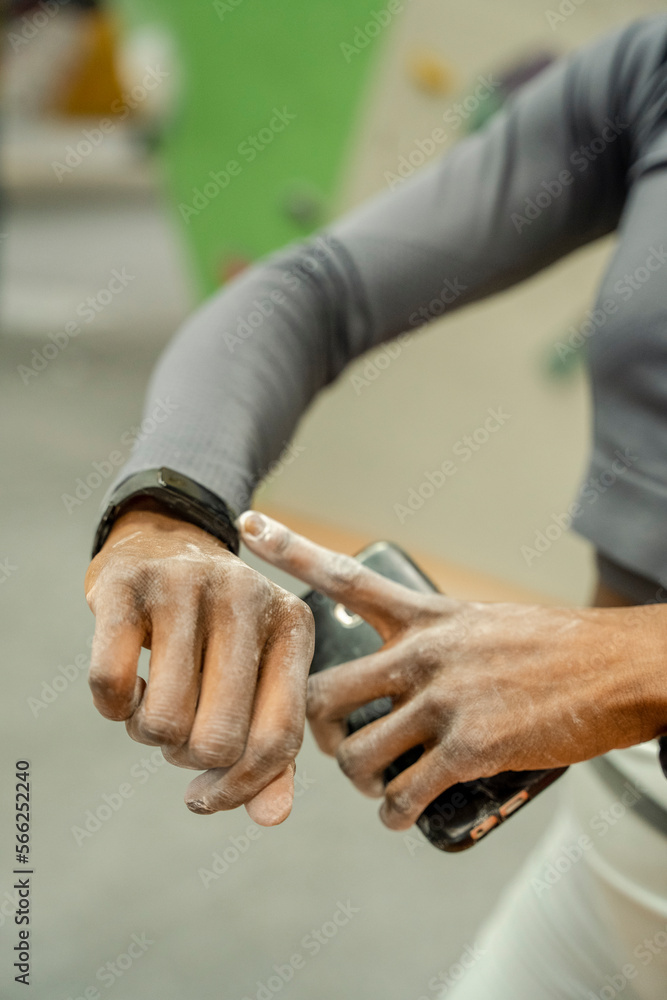Close-up of athlete woman looking at smart watch