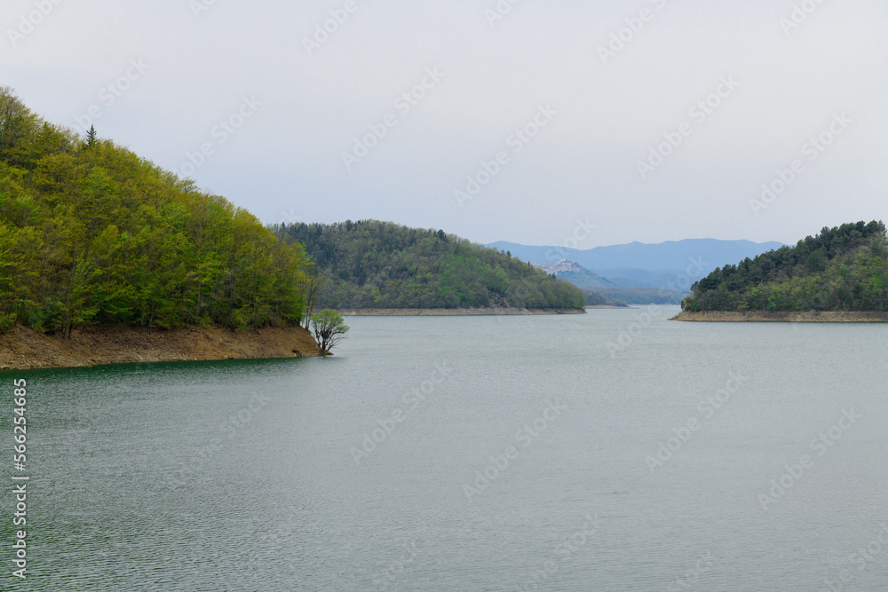 Relax autumn calm landscapes over the Pertusillo lake in val d'Agri, in the Province of Potenza, Basilicata, Italy. The concept of fall cloudy weather, contemplation, relaxation, tranquility, peace. Relax autumn calm landscapes over the Pertusillo lake in val d'Agri, in the Province of Potenza, Basilicata, Italy. The concept of fall cloudy weather, contemplation, relaxation, tranquility, peace.
