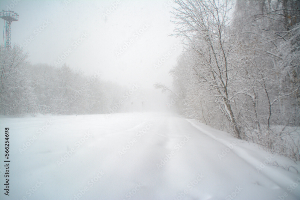 Landscape with snow-covered railroad tracks in the forest between the trees. Landscape with snow-covered railroad tracks in the forest between the trees.