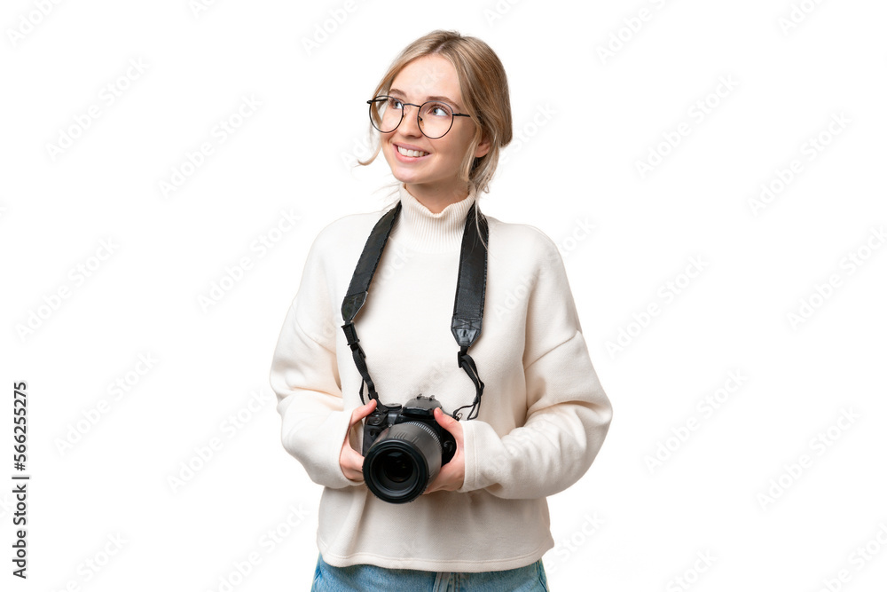 Young photographer English woman over isolated background looking up while smiling