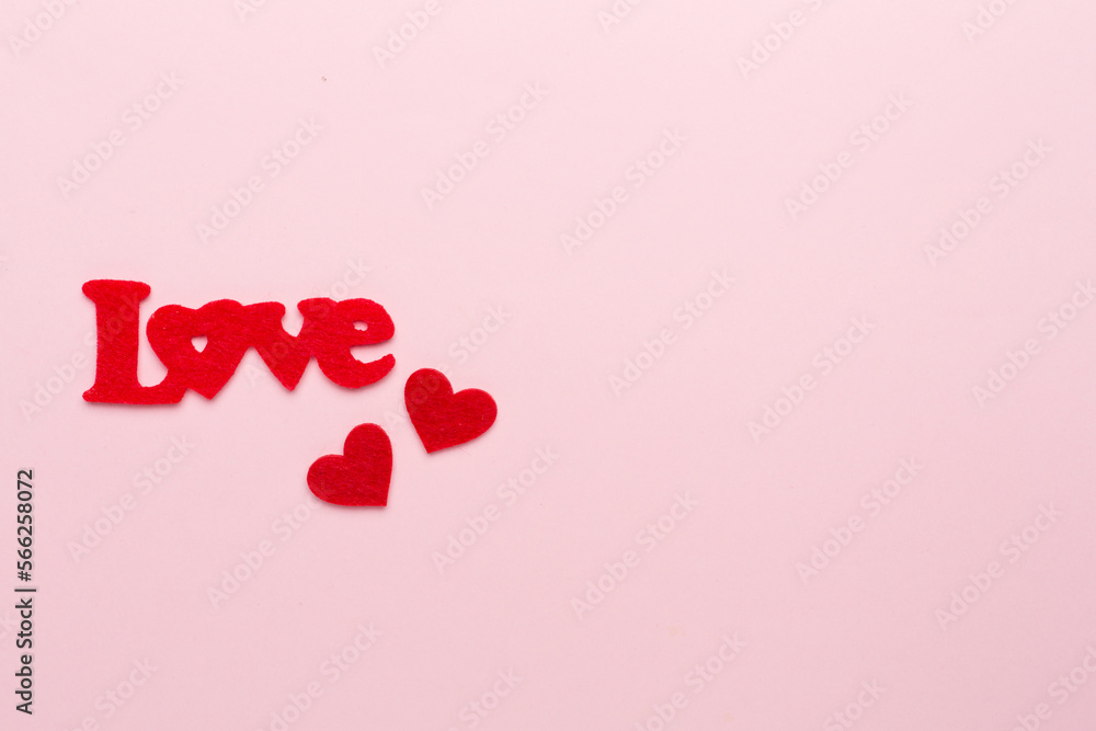 Felt word love with hearts on color background, top view