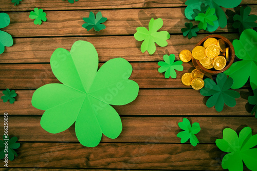 background of clover with gold coins on wood. copy space